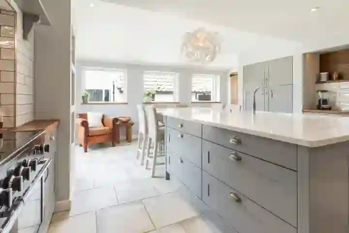 Shaker style kitchen with quartz worktop and designer pendant 