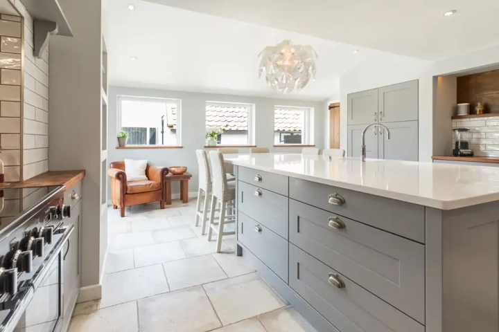 Shaker style kitchen with quartz worktop and designer pendant