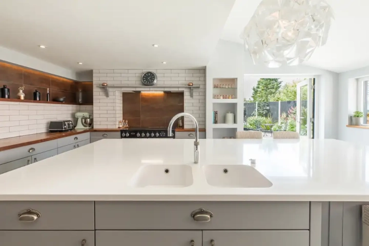 Quartz kitchen island, walnut worktops with grey shaker style cupbaord doors and drawers