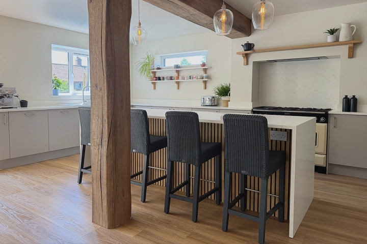Contemporary kitchen with oak beams and dining table