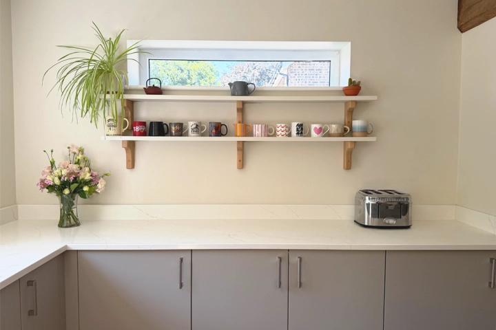 Contemporary kitchen with oak beams close up of integrated hob and electric extractor