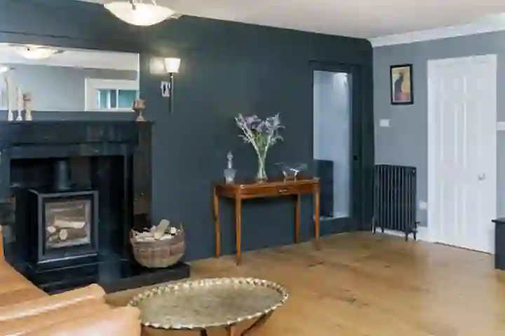 Cinema room with oak flooring and wood burner