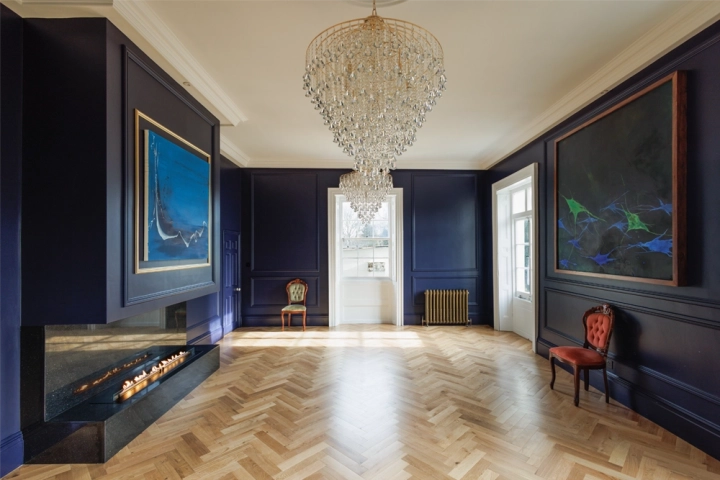Classic art gallery with chandeliers and indigo walls