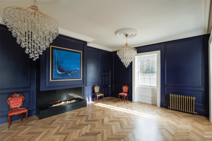 Bespoke art gallery with bioethanol fire, indigo walls and herringbone floor 