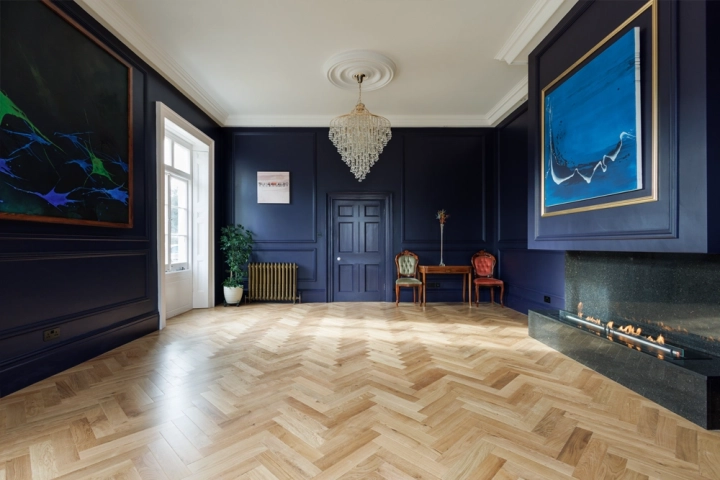 Classic contemporary art gallery with herringbone floor and wall panelling 