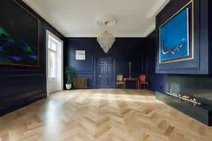 Classic contemporary art gallery with herringbone floor and wall panelling 
