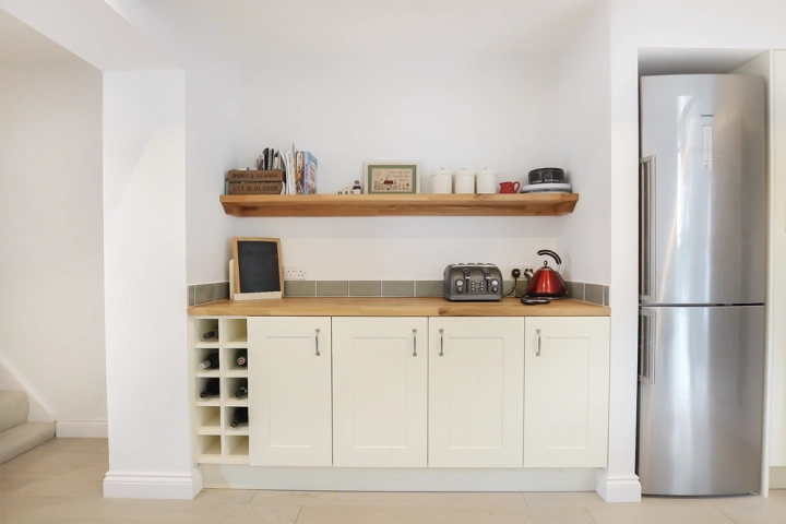 Kitchen bar with oak worktop and fridge freezer