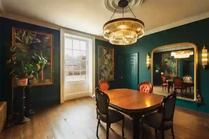 in Georgian house, green panelling and decorative artwork with antique dining table