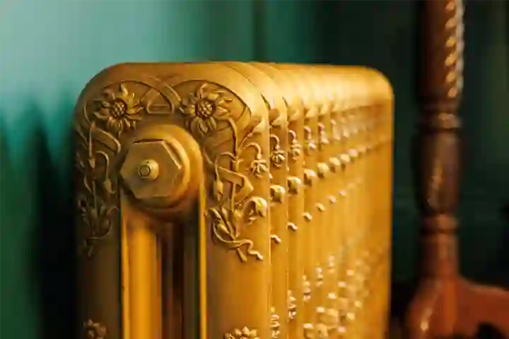 in Georgian house, green panelling. Close up of stylish gold radiatior