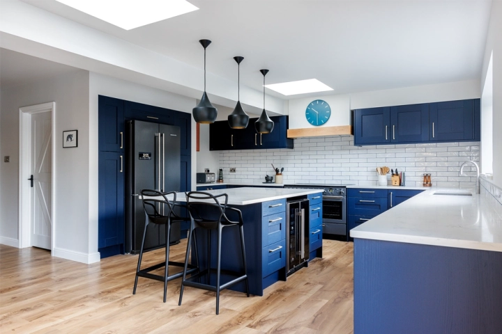 Modern kitchen diner with blue cabinets and doors, kitchen island with modern barstools