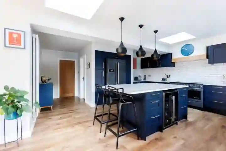 Modern kitchen diner with blue cabinets and doors, kitchen island with modern barstools