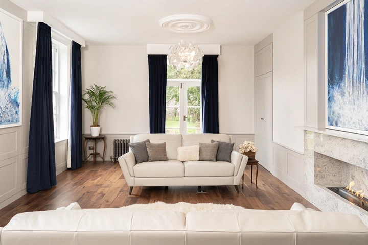Drawing room with twin sofas and high windows