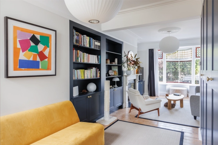 Contemporary lounge with in built cupboards and stylish furnishings with modern art picture