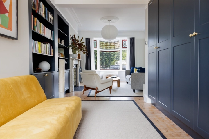 Contemporary lounge with in built cupboards and stylish furnishings