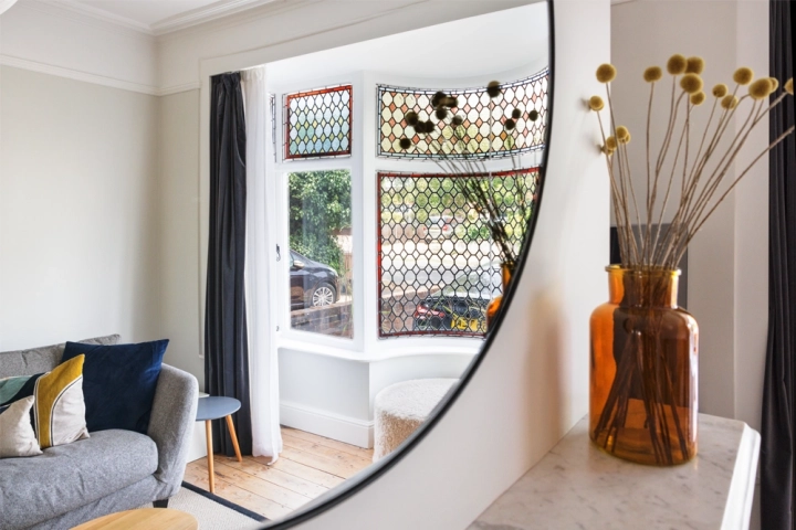 Contemporary lounge with in built cupboards and stylish furnishings