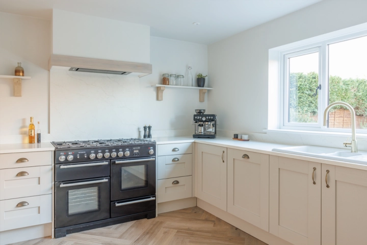 Close-up of shaker-style grey cabinets with soft-close drawers and stainless steel handles.
