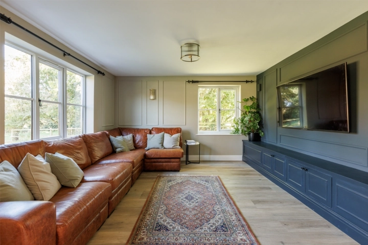 Country traditional longue with bespoke built-in dark media wall and panelling