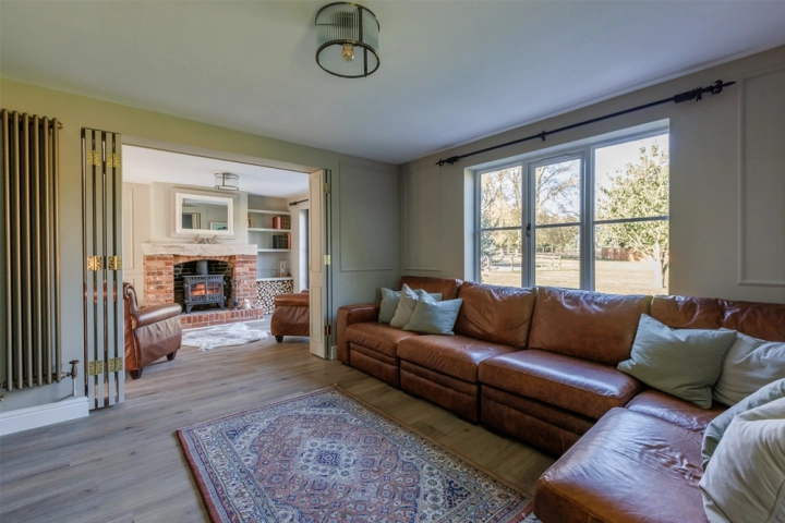 Country longue with cinema room divided by bespoke folding doors