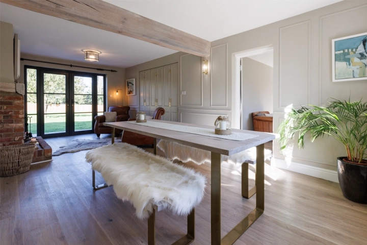 Country longue/diner with bespoke wall panelling and long table