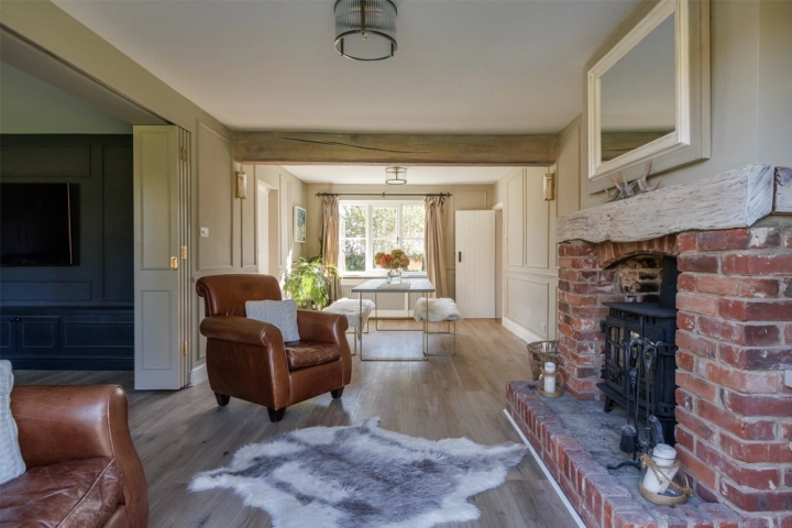 Country longue-diner with oak exposed beams and brick fireplace