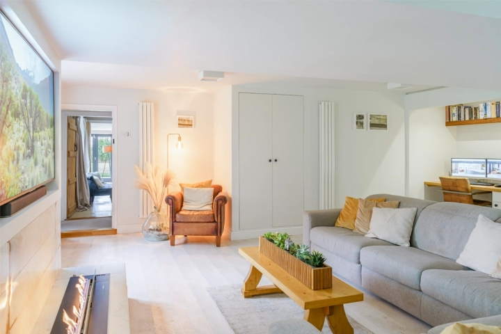 Home office with white cork flooring and bioethanol fire