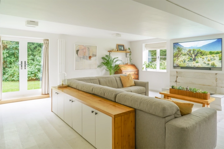 Home office with an L-shaped sofa and cork white flooring