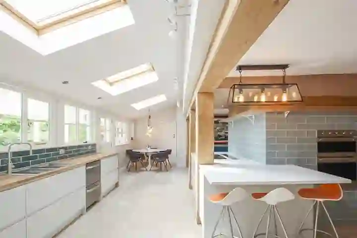 Contemporary kitchen with oak beams and bar seating