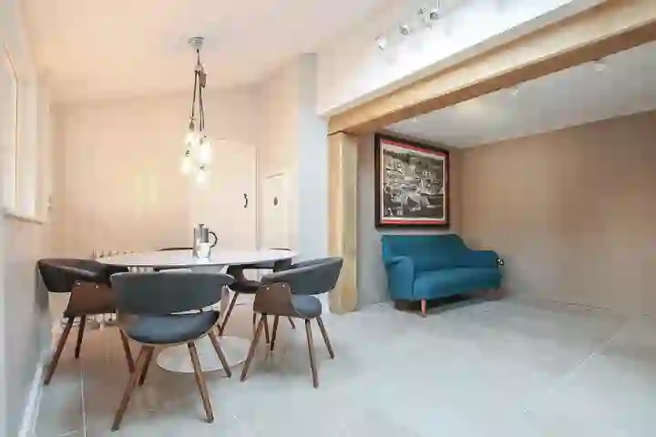 Contemporary kitchen with oak beams and dining table