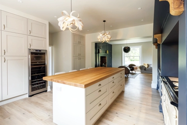 Contemporary kitchen with oak beams and bar seating