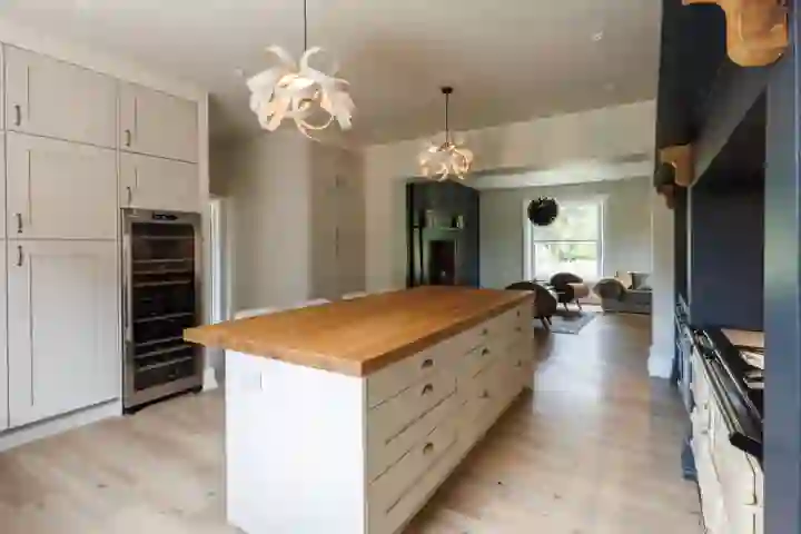 Contemporary kitchen with oak beams and bar seating