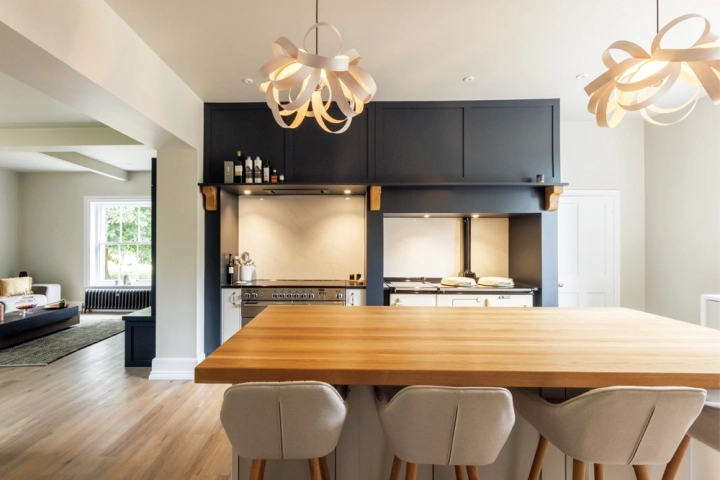 Contemporary kitchen with oak beams and dining table