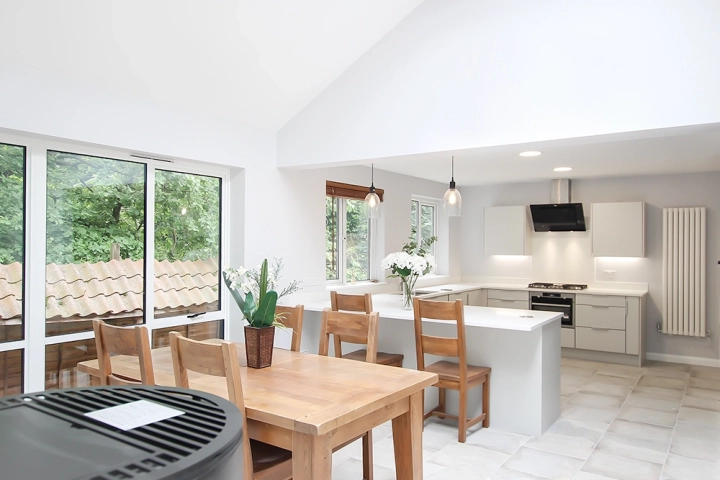 Modern kitchen diner with in built appliances and dining table