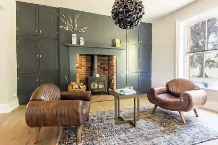 Bespoke dark media wall with lit inlaid glass art deco detailing 