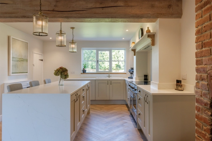 Farmhouse kitchen with herringbone floor and exposed oak beam