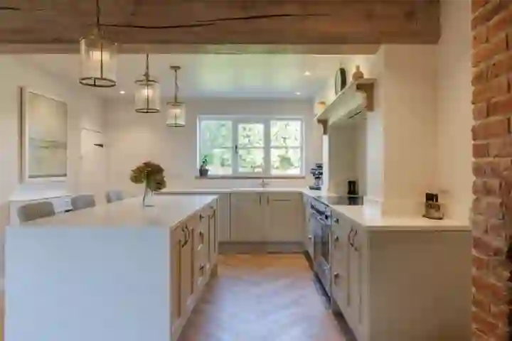 Farmhouse kitchen with herringbone floor and exposed oak beam