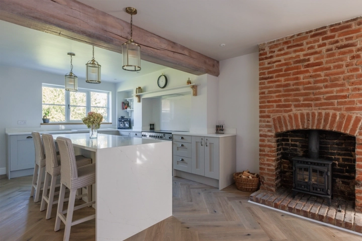 Farmhouse kitchen with exposed brick fireplace