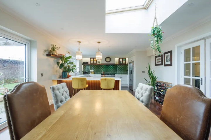 Open plan kitchen with skylight, geenn metro tile splashbacks, modern pendant light